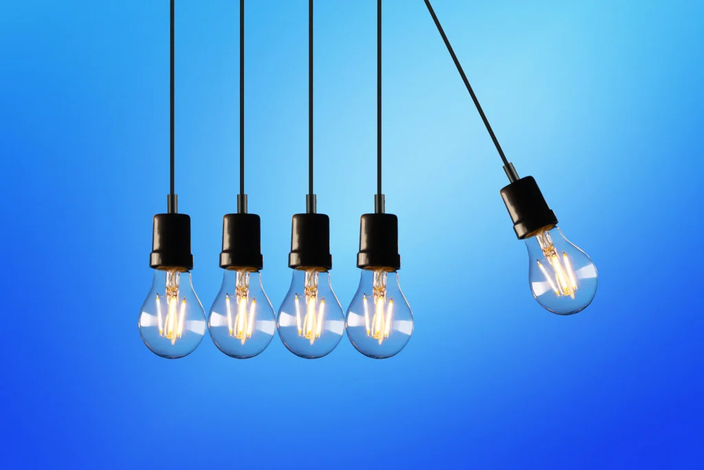 5 lightbulbs, with one swinging into the others