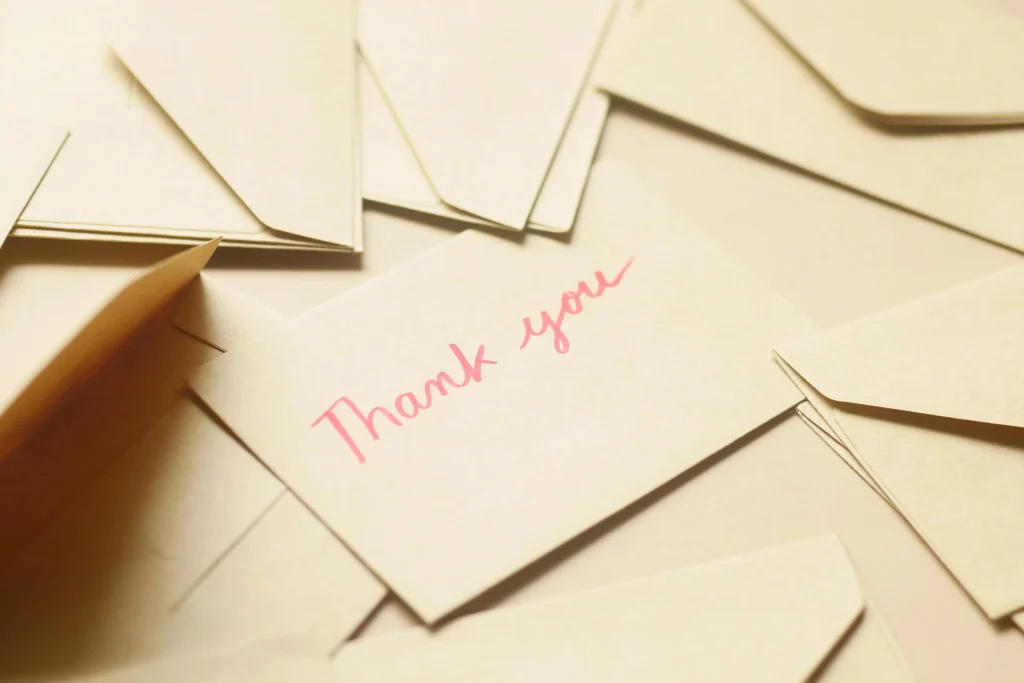 "thank you" written on an envelope